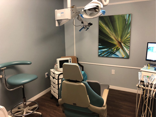 Room for the endodontist with rolling stool, patient chair and equipment.